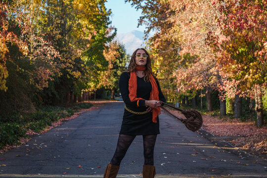 Happy blonde woman enjoying autumn in the park.