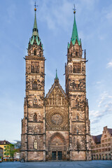 Fototapeta premium Gothic west facade of St. Lorenz Church with twin towers in Nuremberg, Germany. Exterior view, medieval architecture style