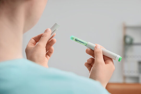 Female doctor with hormone injection in clinic, closeup