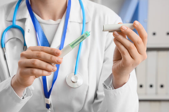 Female doctor with hormone injection in clinic, closeup