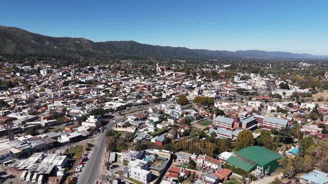 Aerial drone shot of La Falda city in the scenic Punilla Valley, Cordoba, Argentina.
