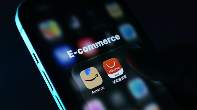 Closeup of a smartphone screen showing ecommerce applications like amazon and aliexpress seller, with a finger touching the screen