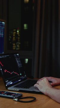 Trader man works at home using workstation and analysis stock chart. Workplace of crypto exchange broker. Global financial markets, business strategy, currency btc, investing. Laptop screen display