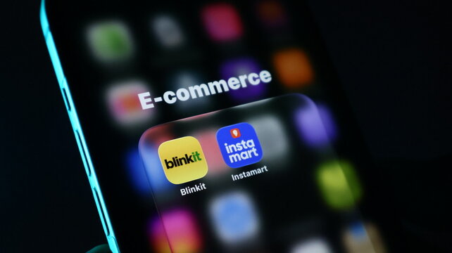 Closeup of a smartphone screen showing ecommerce folder with blinkit and swiggy instamart apps in india