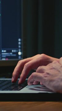 Man stock trader in home office, typing on a laptop keyboard. Male forex broker analyzes terminal, trades stocks on crypto market. Smartphone monitor, candlestick or trading charts, price action