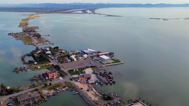 Aerial video showcasing the sprawling network of roads, seafood restaurants, and resorts across the waters of Patok Lagoon.