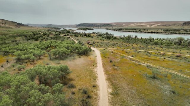 Aerial View offroad vehicle near river in South Kazakhstan