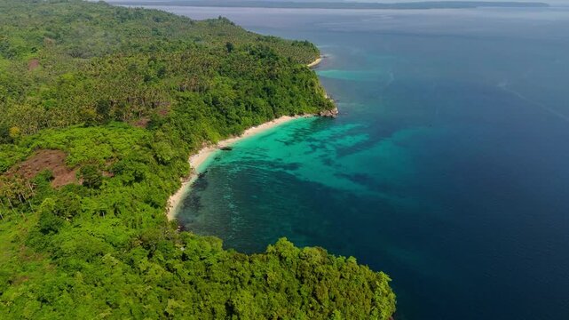 Cinematic aerial view of Mandel Beach on Banggai Island &ndash; Breathtaking drone shot of white sandbar and vibrant coral reef in crystal clear turquoise ocean, Central Sulawesi Indonesia paradise 4k