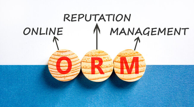 ORM online reputation management symbol. Concept words ORM online reputation management on beautiful wooden circles. Beautiful white blue background. Business ORM concept. Copy space.