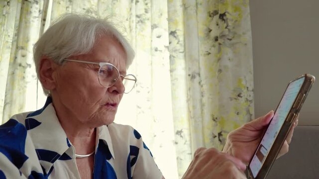 Senior Woman Using Smartphone at Home
