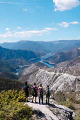 Fototapeta premium Group of hikers enjoying breathtaking mountain views in a serene landscape during a sunny day