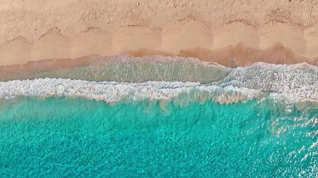 Turquoise sea waves on a sandy tropical beach, view from above. The surf, a stunning backdrop of tropical nature. The vibrant Mediterranean Sea, bay waves lapping the beach, sandy coastline.