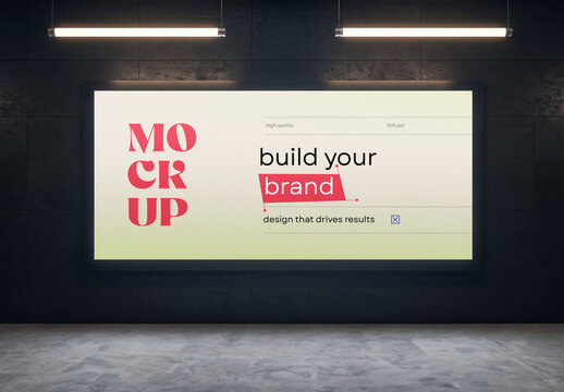 Horizontal large digital billboard mockup mounted on a dark tiled wall under overhead linear lights in a modern studio or subway station interior