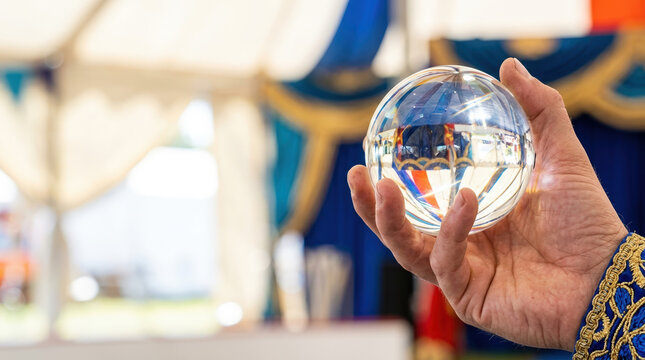 Juggler Holding Crystal Ball in Circus Tent for World Juggling Day Celebrations, Entertainment Events, Performance Art, Festivals, and Social Media Content