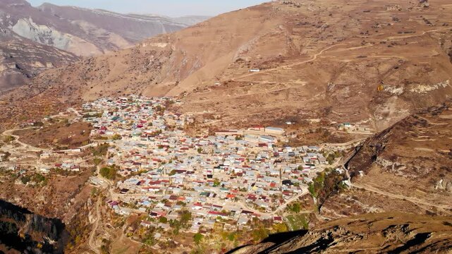 Sunlit Terraced Village Amid Colorful Foliage. Panoramic Shot Of Hillside Homes And Winding Trail . Media