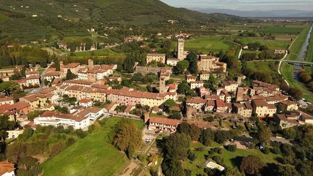 Vicopisano Tuscany Aerial 4K. Drone cinematic view of hidden gem medieval village and castle among green fields. Authentic Tuscan countryside landscape with Brunelleschi tower overview