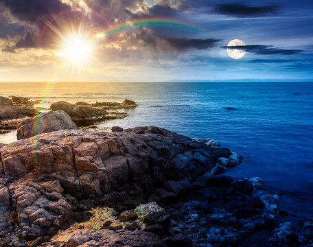 sea coast with stones and rocks. day meet night. summer vacation background at twilight. sun and moon in harmony over seascape with rough terrain. relaxing at the sea. coast of bulgaria wallpaper