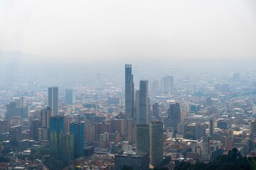 Obraz premium Aerial view of Bogotá cityscape under dramatic cloudy sky, Colombia