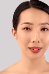Obraz premium Beautiful Asian woman on light background, closeup