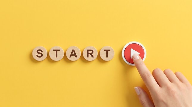 A human finger presses a circular red play button next to five wooden discs arranged horizontally spelling out the word start on bright yellow background