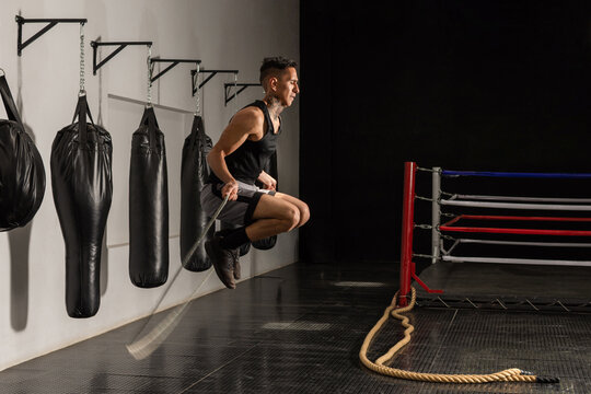 Young Hispanic boxer jumping rope during training in boxing gym