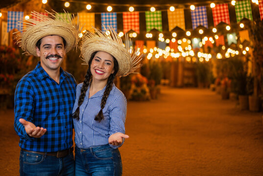 brazilian couple, clothes from festa junina, inviting to the party, arraial, festa de s&atilde;o jo&atilde;o. boyfriend and girlfriend. Celebrating.frre space.