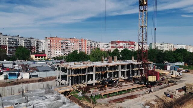 Drone flying toward residential building under active construction