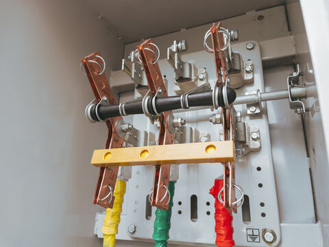 Close-up photo inside a high-power three-phase electrical switchboard with industrial breakers and heavy wiring, illustrating energy distribution and electrical infrastructure.