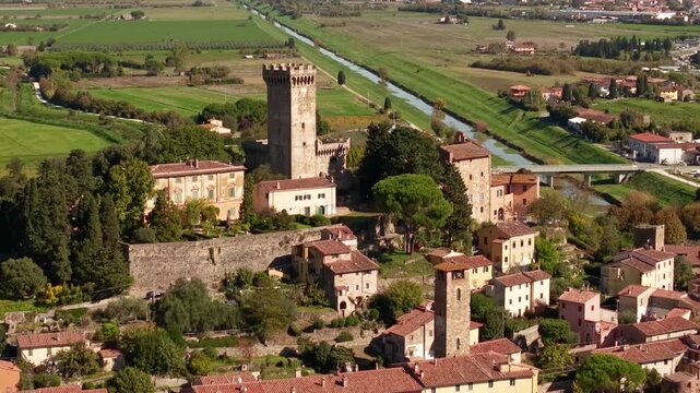 Vicopisano Tuscany 4k drone footage of medieval borgo castle tower. Cinematic aerial pull back reveal flight of hidden gem Italian village and green valley landscape
