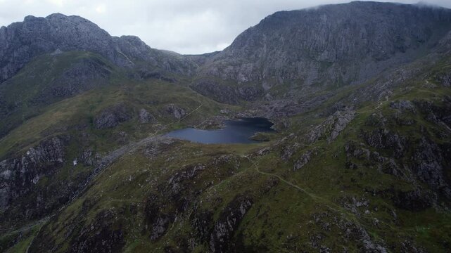 Mountain Tarn Beneath Rugged Snowdonia Peaks