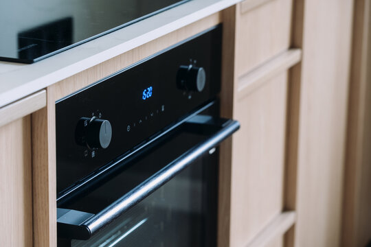Modern kitchen with built-in electric oven and ceramic cooktop