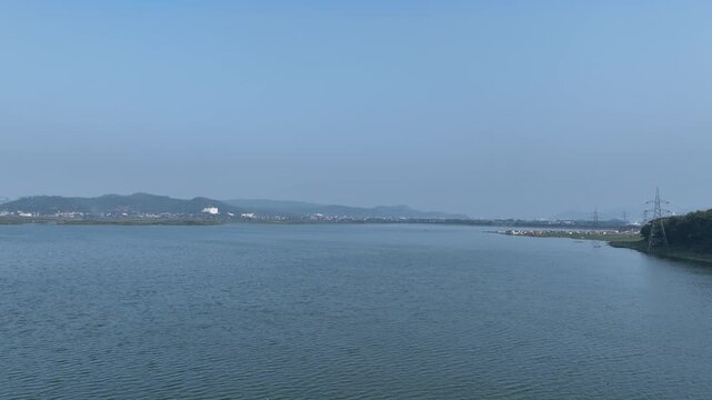An aerial drone shot beautifully captures the stunning natural beauty of Deepar Beel, located in Guwahati, Assam, showcasing its serene waters and lush green surroundings.4k