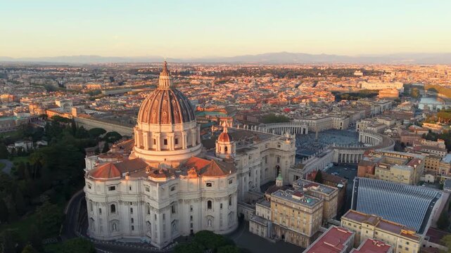 Aerial city view St. Peter's basilica in Rome, aerial shot at sunset with drone. San Pietro, Roma. 