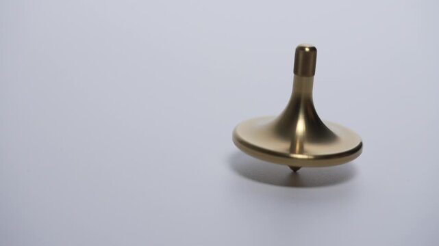 Seamless Infinite Loop of Golden Spinning Top on White Background