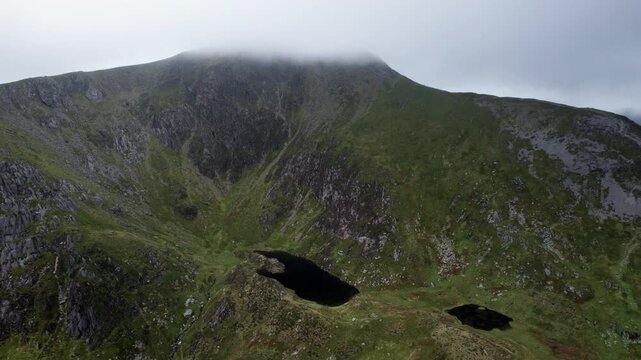 Aerial View of Mountain Tarn Beneath Misty Summit in Snowdonia