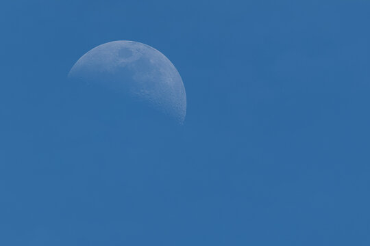 Half moon in cloudless blue sky