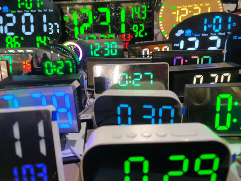 Glowing digital clock showing the time in green digits on a black background.