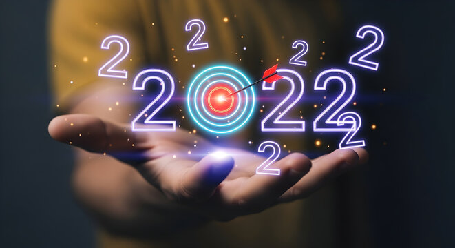 Achieving Business Goals in 2022 with Glowing Neon Target and Arrow for Success Concepts.