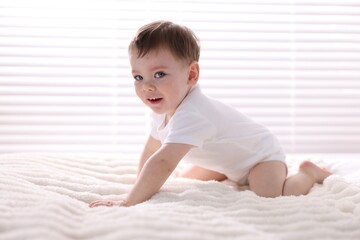 Fototapeta premium Cute little baby boy on bed at home