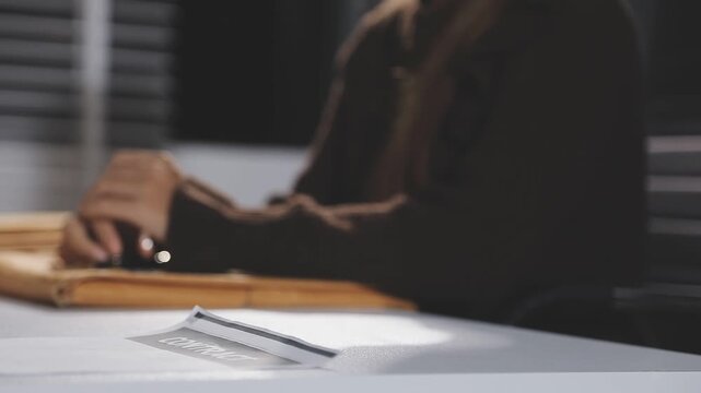 The real estate agent closes the deal with the client and they sign the contract.