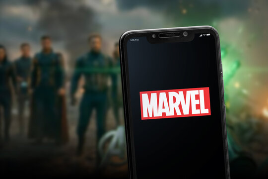 Cali, Colombia - May 28 2026: Smartphone displaying Marvel logo with superhero cinematic background