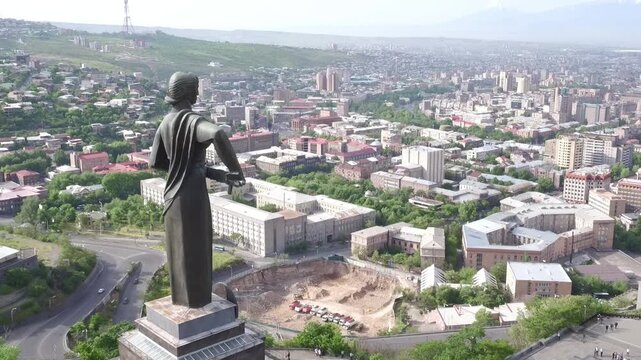 Aerial view of the Mother Armenia monument in Yerevan, featuring a military ceremony at the base of this giant statue on a bright sunny day in late spring.

