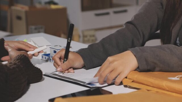 The real estate agent closes the deal with the client and they sign the contract.