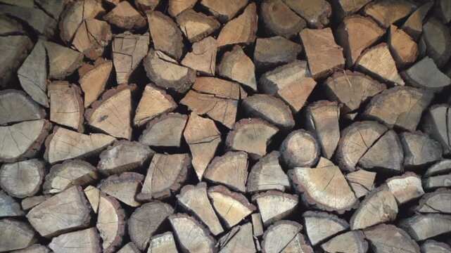 Logs stack texture, log background. Wood, chopped firewood. Closeup video, slow motion. 