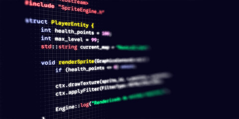 Macro photograph of a dark computer monitor displaying C game development code with colorful syntax highlighting © Jess rodriguez