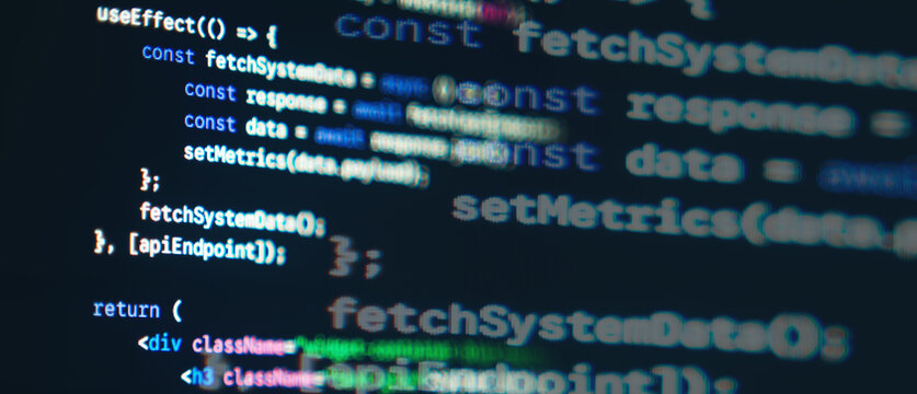 JavaScript React frontend code with fetch API syntax displayed on a dark monitor screen