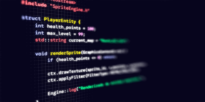 Macro photograph of a dark computer monitor displaying C game development code with colorful syntax highlighting
