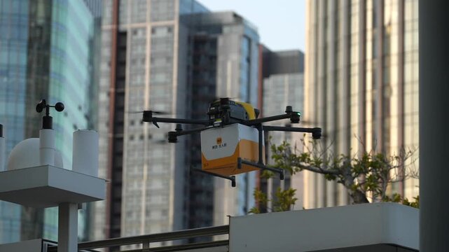 Modern autonomous quadcopter drone deliver packages in modern City Environment. Advanced technology of Logistics. China.