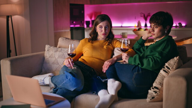 Two ladies resting couch enjoying cozy domestic evening atmosphere closeup. 