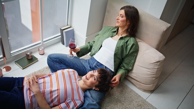 Relaxed besties talking together feeling emotional connection in home closeup. 